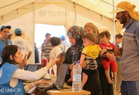 UNHCR staff registering Syrian refugees in Jordan at the Zaatri refugee camp. Photo: UNHCR / A. Rummery 