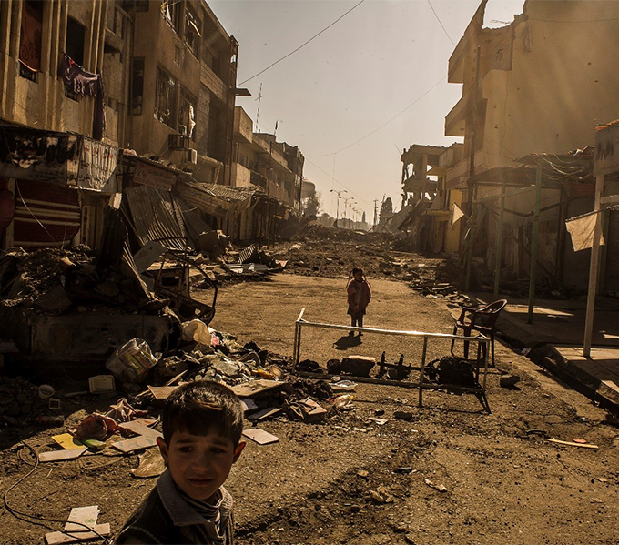 Children playing in the streets. Many of the houses and civilian infrastructure has been destroyed during the offensives. Photograph credit: ICRC 2017